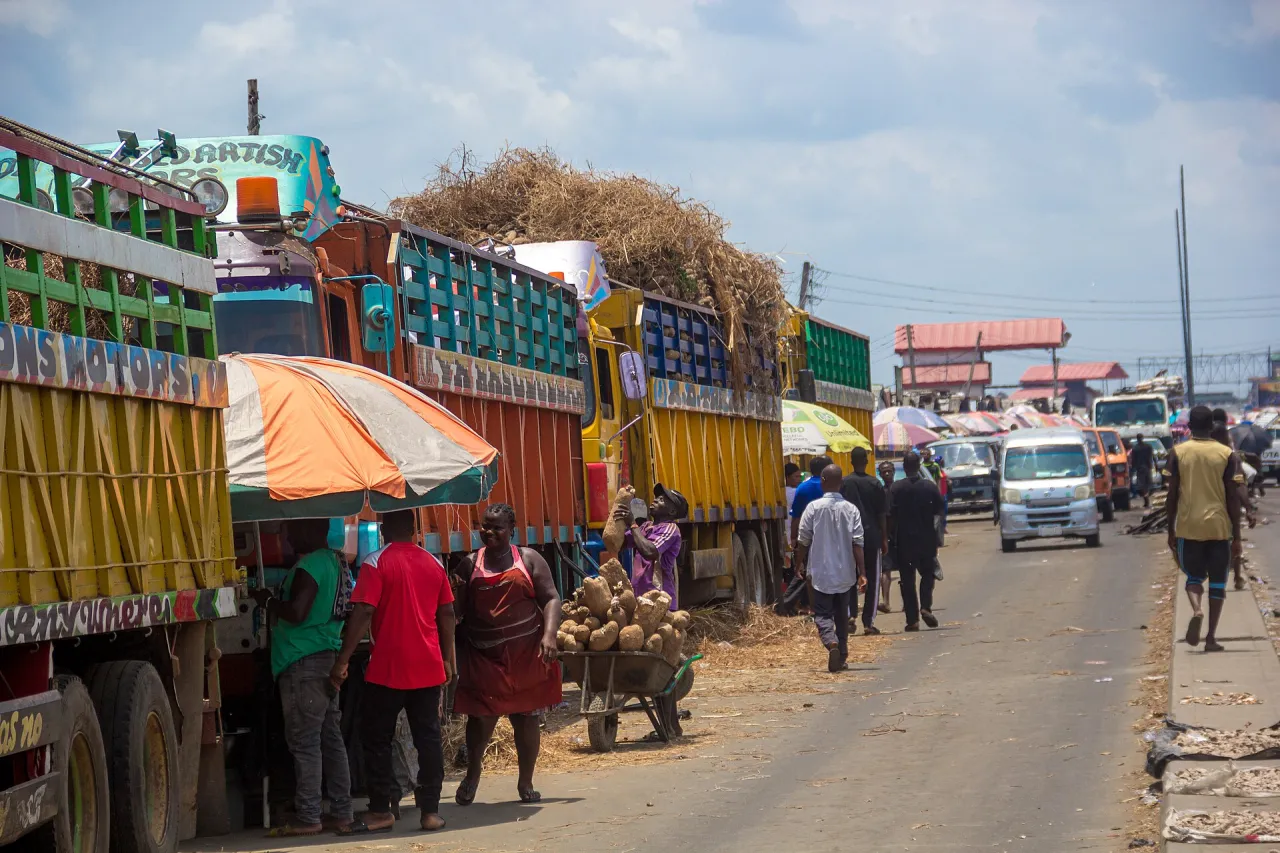 Large trucks carrying agricultural produce beside a market road in Port Harcourt Nigeria
