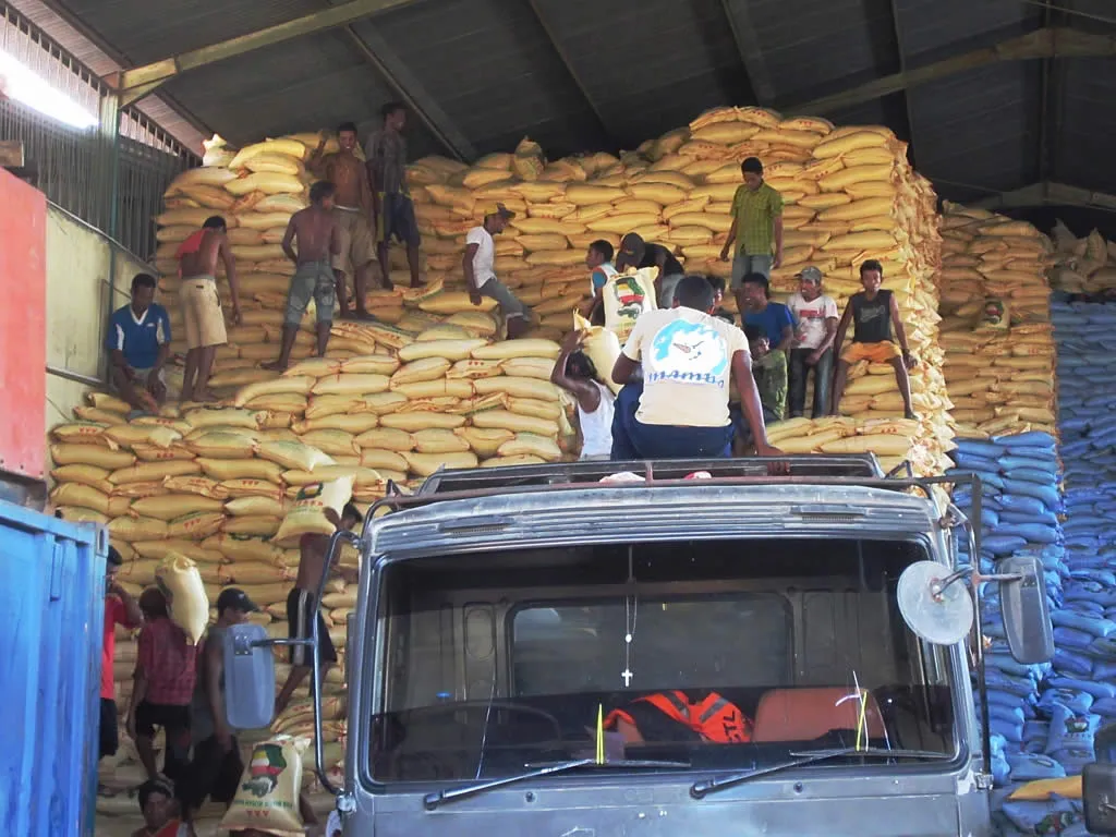 Rice bags being unloaded at a warehouse in Dili